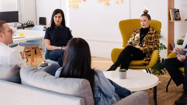 Group of people sat in a circle in discussion